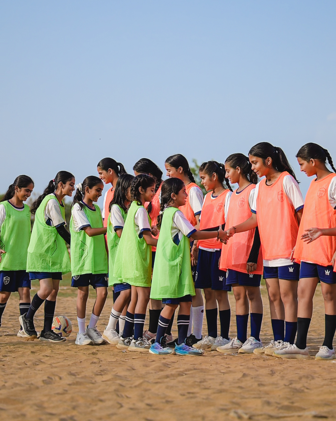 Rajasthan FC girls' teams shaking hands